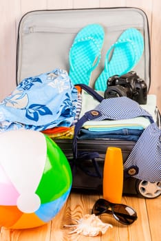 open packed suitcase with things collected for vacation