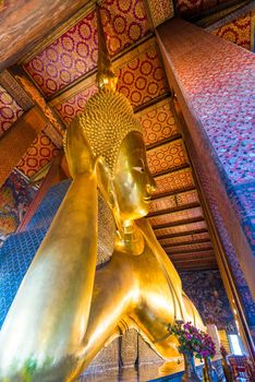 big lying Buddha in a temple in Bangkok, close-up