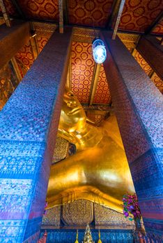 god Buddha in the Temple of the Reclining Buddha in Bangkok, Thailand