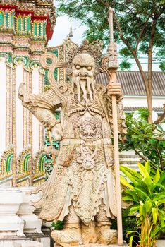a terrible stone guard is located near the temple in Bangkok