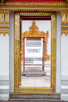 white temple wall and beautiful rich finish close-up, entrance to the temple, Bangkok, Thailand