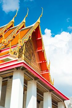 beautiful roof of temple of Thailand with sharp peaks against the blue sky