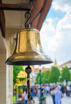 large brass bell on the territory of the palace in Bangkok close up