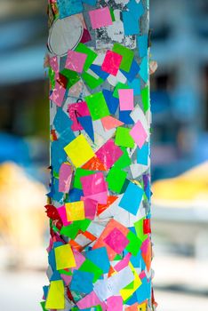 close-up of colored stickers on a pillar in the street of Thailand