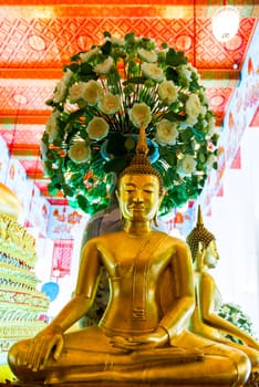 temple of Bangkok - sitting Buddha and beautiful flowers