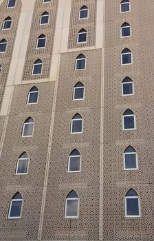 The windows on the exteriors of a building with traditional Islamic architecture.