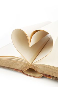 Heart shaped book pages on white background