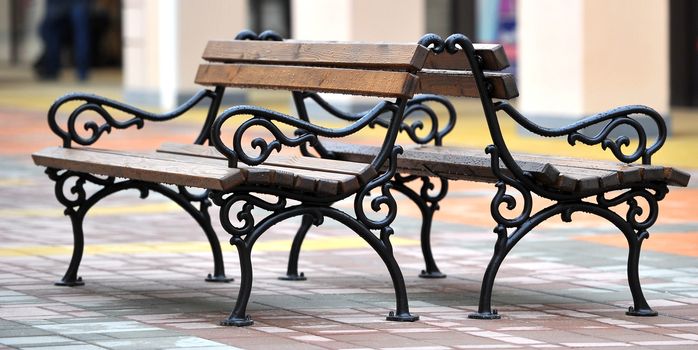 Two benches on the street no people sitting