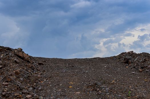 Dumps rock mountains from industrial quarries.