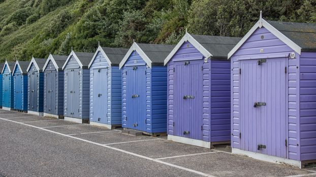 A row of painted wooden beach huts on the promenade at Bournemouth summer vacation