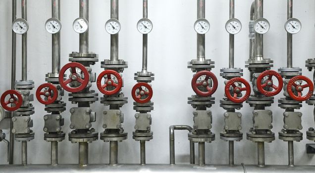 Colorful valves in industrial plant on pipes