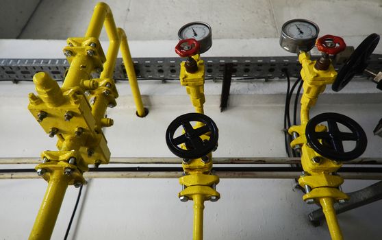 Colorful valves in industrial plant on pipes