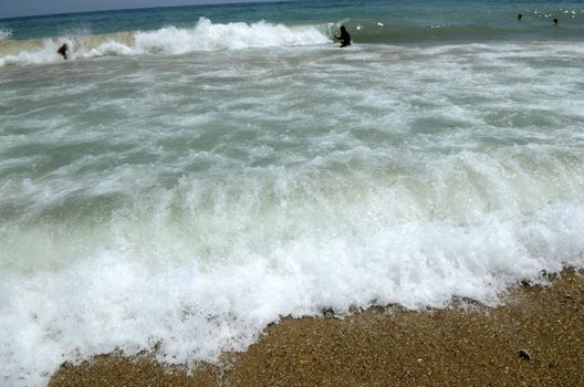Waves on the beach on sunny summer day
