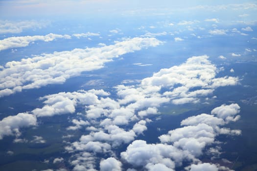 Blue and silver clouds background, view from airplane