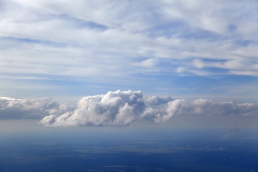 Blue and silver clouds background, view from airplane