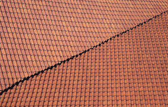 Roof of a house covered with new red tiling