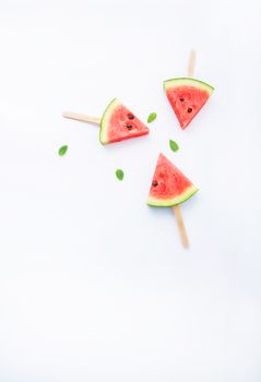 Fresh and sweet watermelon slice popsicles on white background