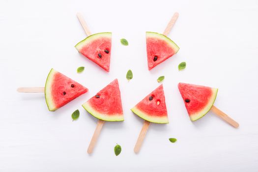 Watermelon slice popsicles on white background