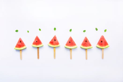 Fresh and sweet watermelon slice popsicles on white background