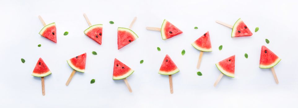 Watermelon slice popsicles on white background