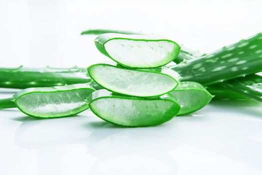 Aloe vera fresh leaves with slices aloe vera gel. isolated over white with copy space.