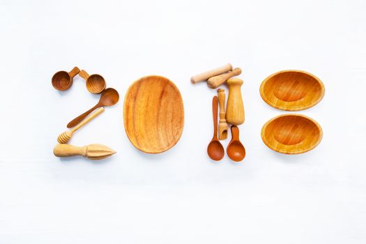  New Year concept for 2018 : Wooden cook's tools idea numbers on white background.