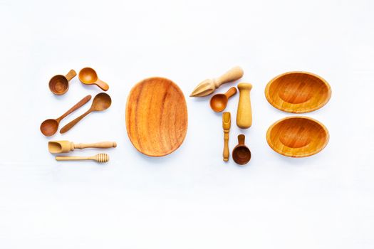  New Year concept for 2018 : Wooden cook's tools idea numbers on white background.