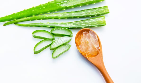 Aloe vera sliced isolated on brown wooden spoon on white background.