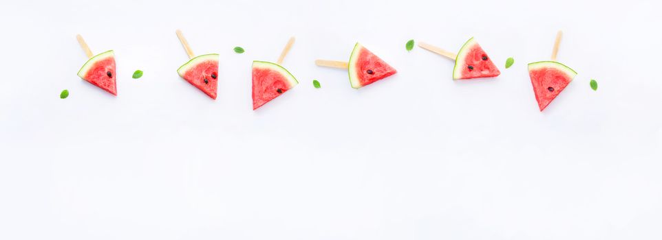 Watermelon slice popsicles on white background