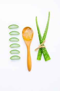 Aloe vera fresh leaves with aloe vera gel on wooden spoon. isolated over white