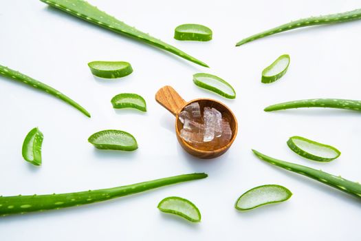 Aloe vera fresh leaves with aloe vera gel on wooden measuring spoon. isolated over white