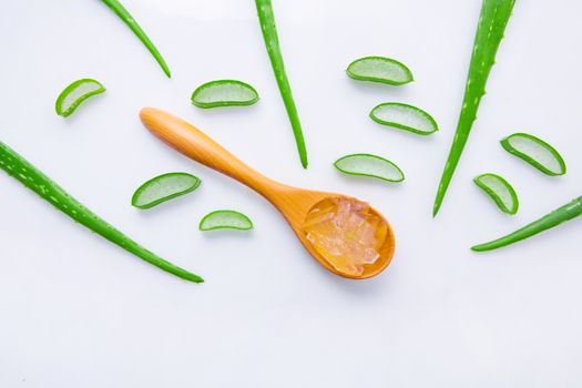 Aloe vera fresh leaves with aloe vera gel on wooden spoon. isolated over white