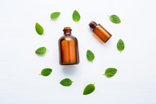 Natural Mint Essential Oil in a Glass Bottle with Fresh Mint