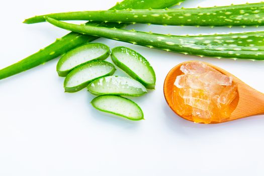 Aloe vera fresh leaves with slices and aloe vera gel on wooden spoon. isolated over white