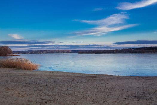 Winter dusk evening paysage landscape of sunset evening iced frozen lake river coastal beach
