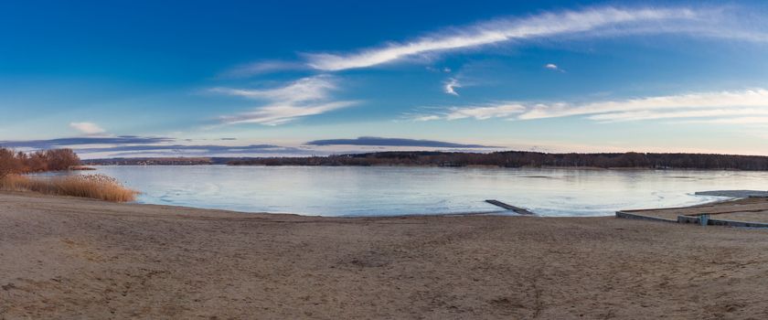 Winter dusk evening paysage landscape of sunset evening iced frozen lake river coastal beach