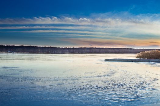 Winter paysage landscape of sunset evening iced frozen lake river