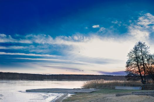 Winter paysage landscape of sunset evening iced frozen lake river
