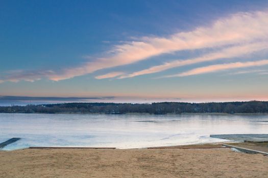 Winter paysage landscape of sunset evening iced frozen lake river coastal beach