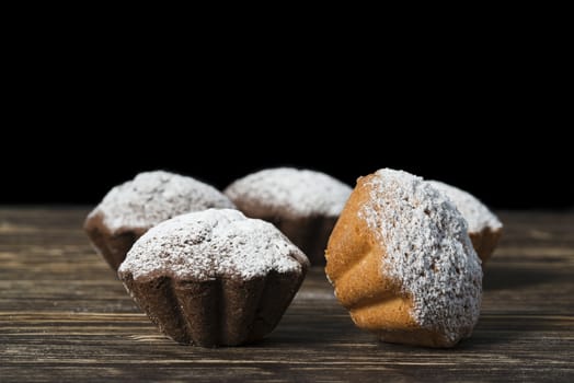 Homemade muffin on brown wooden background