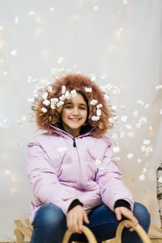 portrait of teenager in studio with pink winter jacket with fur hood