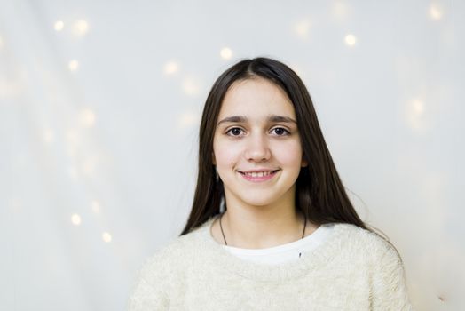 portrait of female teenager with long hair in studio while she laughs