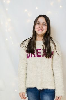 portrait of female teenager with long hair in studio while she laughs