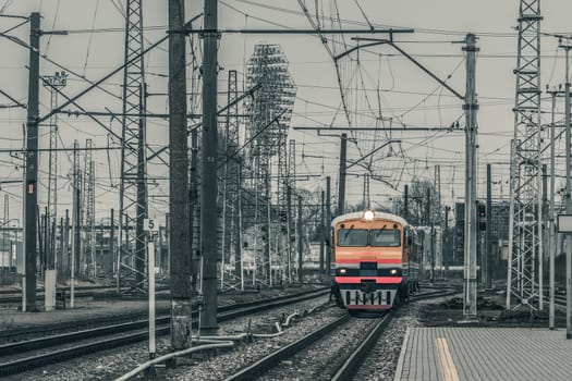 Old yellow passenger diesel train moving at the terminal