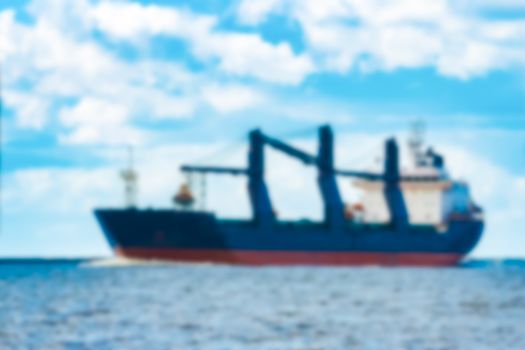 Blue cargo ship - soft lens bokeh image. Defocused background