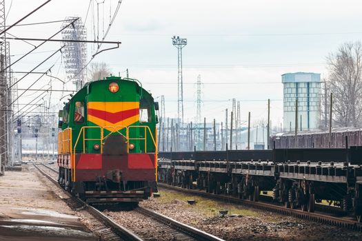 Green diesel cargo locomotive. Freight train in action