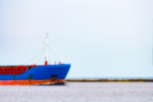 Blue cargo ship - soft lens bokeh image. Defocused background