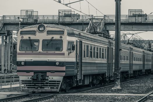 Old passenger electric train riding at the terminal