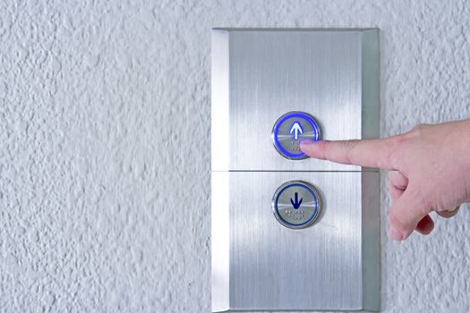 Using hands, press the elevator up and keypad elevator and bottom key