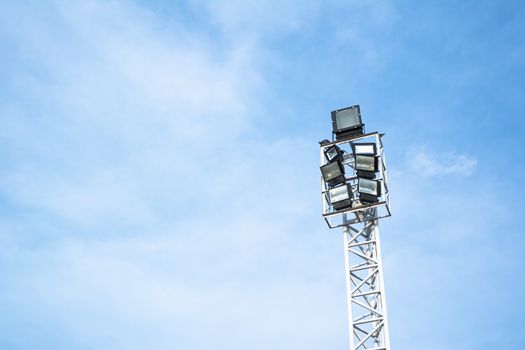 Spotlights electric poles with blue sky for background